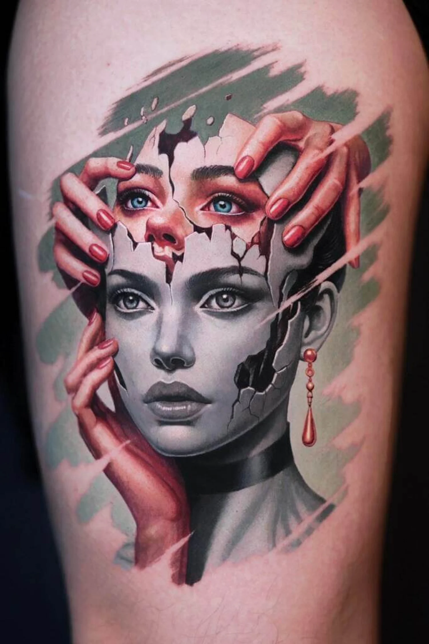 Color surrealism portrait tattoo featuring a woman's face with a cracked mask, expressive blue eyes and realistic hands by Quang Pham at Qneedle Tattoo Studio