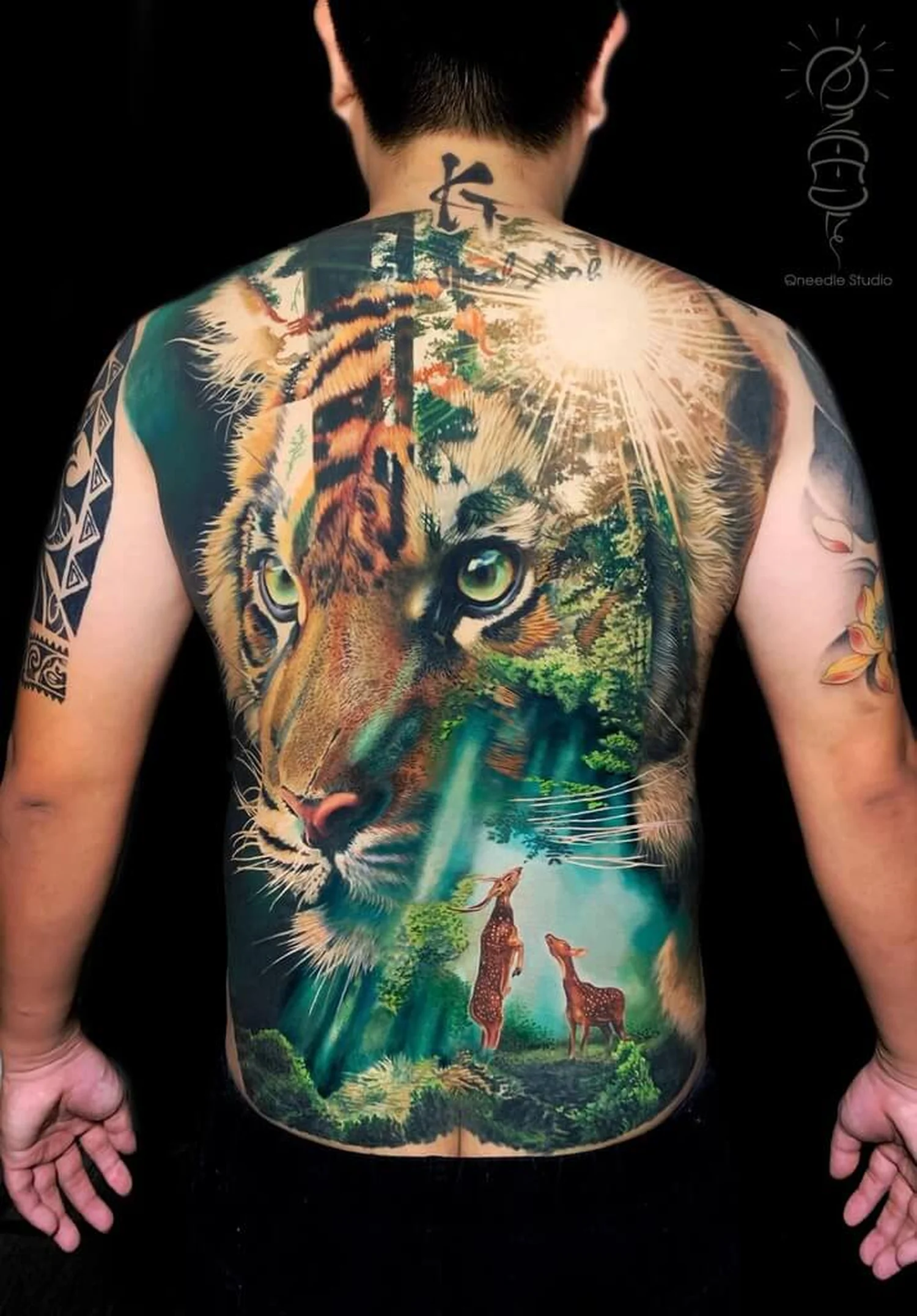 Full back color tiger tattoo with forest background by Quang Pham at Qneedle Tattoo Studio