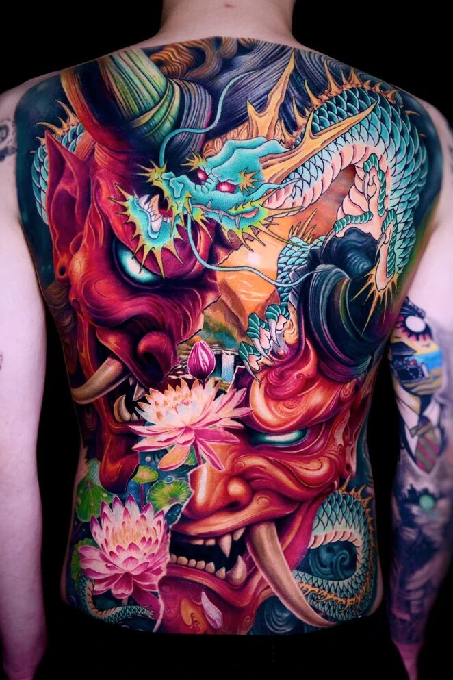 Asian style full back tattoo with oni, lotus and dragon at Qneedle Tattoo Studio
