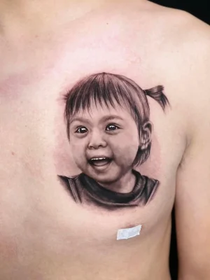 smiling black grey baby girl portrait Qneedle Studio